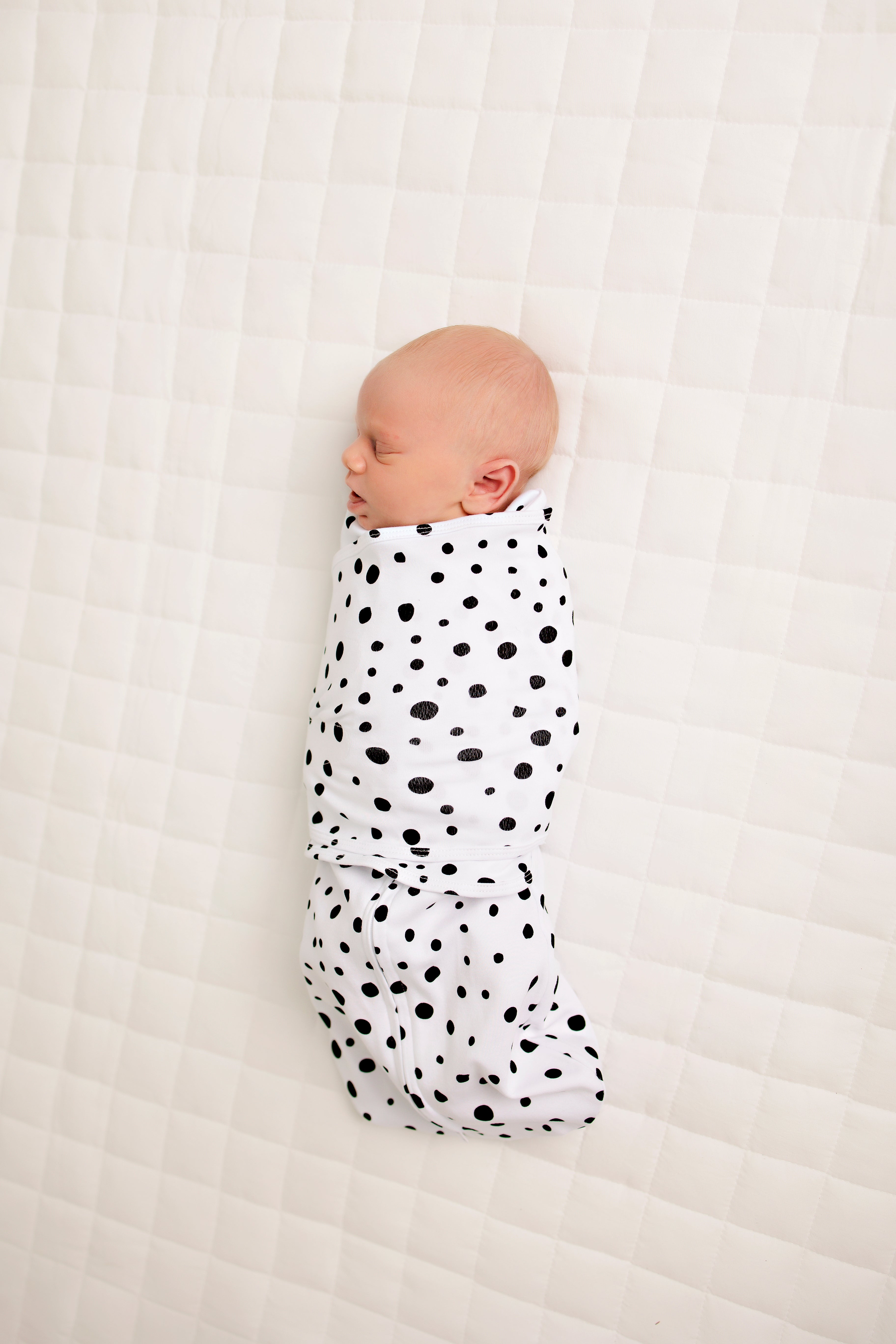 Newborn sleeping in LullaBaby Swaddle - Oreo