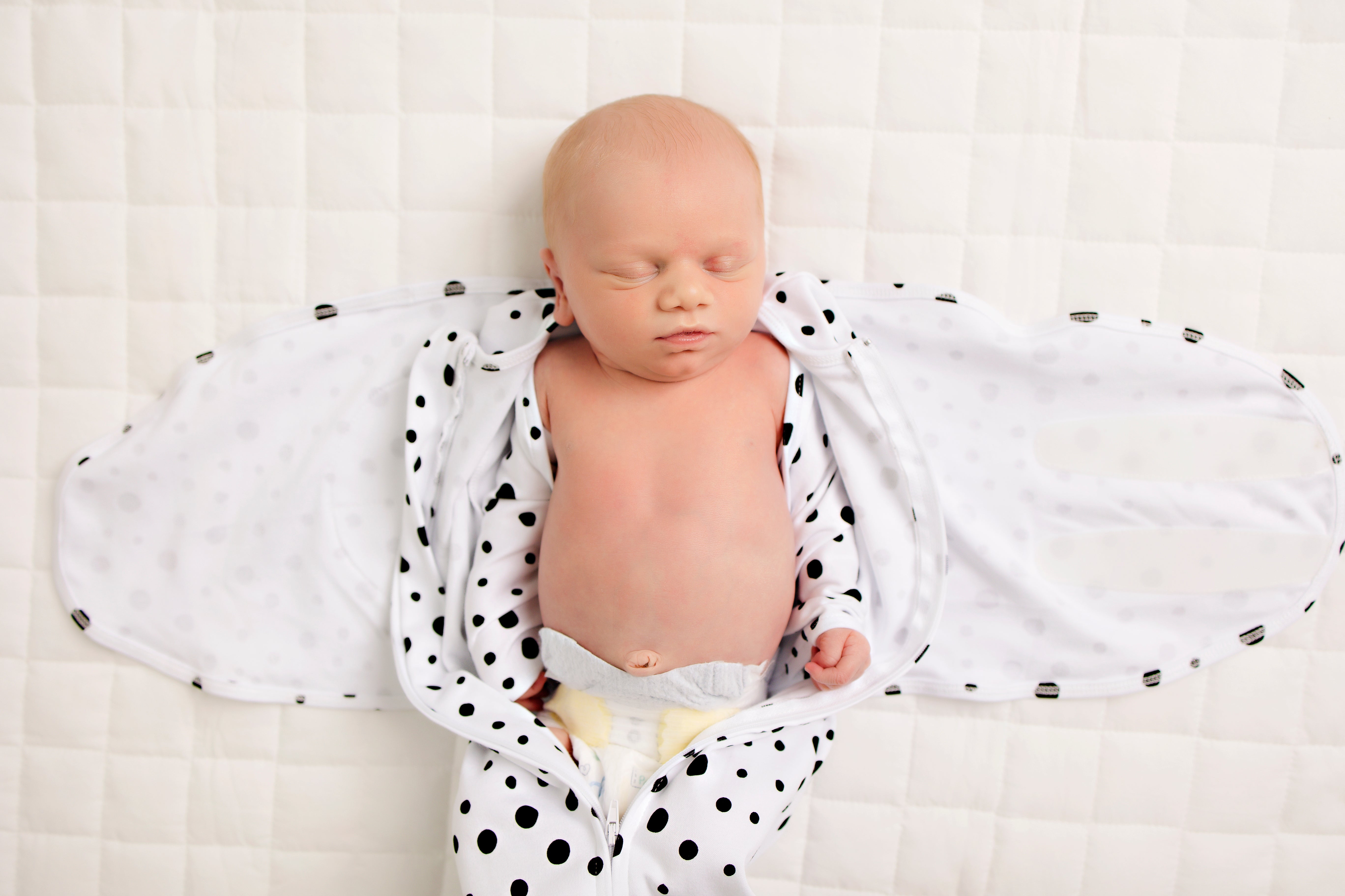 Newborn being wrapped in the LullaBaby Swaddle - Oreo